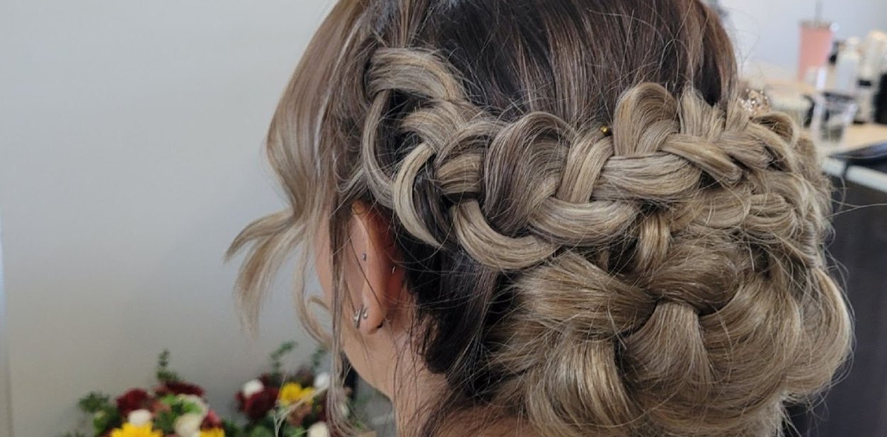 Close-up of a loose Dutch braid sweeping around the head into a low bun