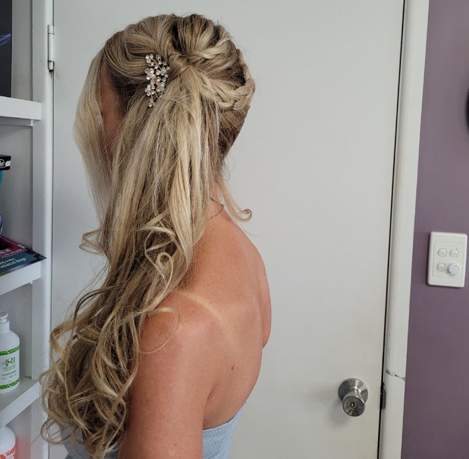Long blonde half-up style with a braid, soft curls and a crystal comb