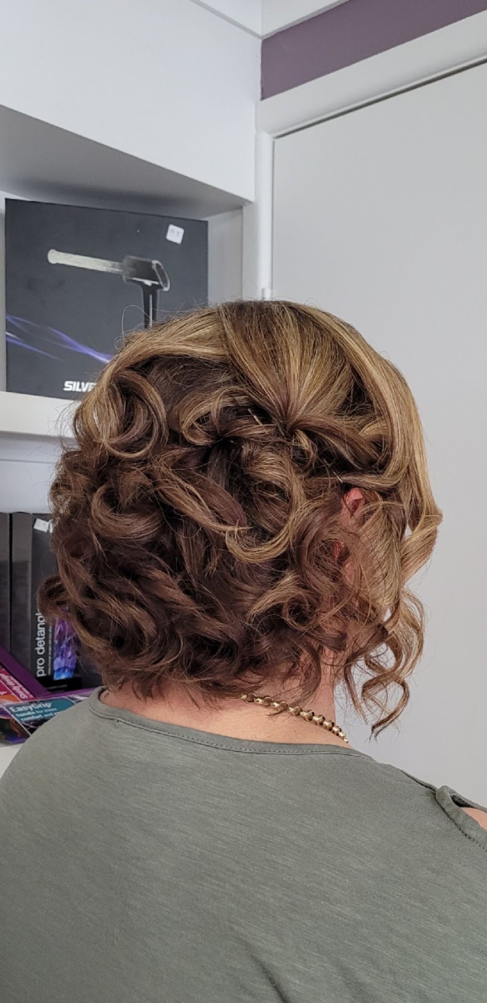 Short hair pinned into a soft sculpted updo of curls