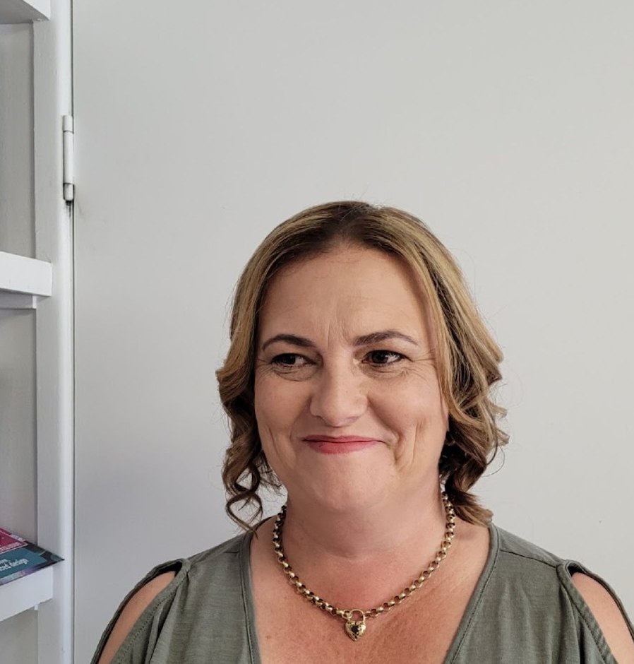 A client smiling after her curled and pinned style